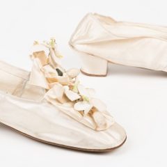 A pair of wedding slippers in ivory silk satin with 1 ½ inch 'knock-on' heels.